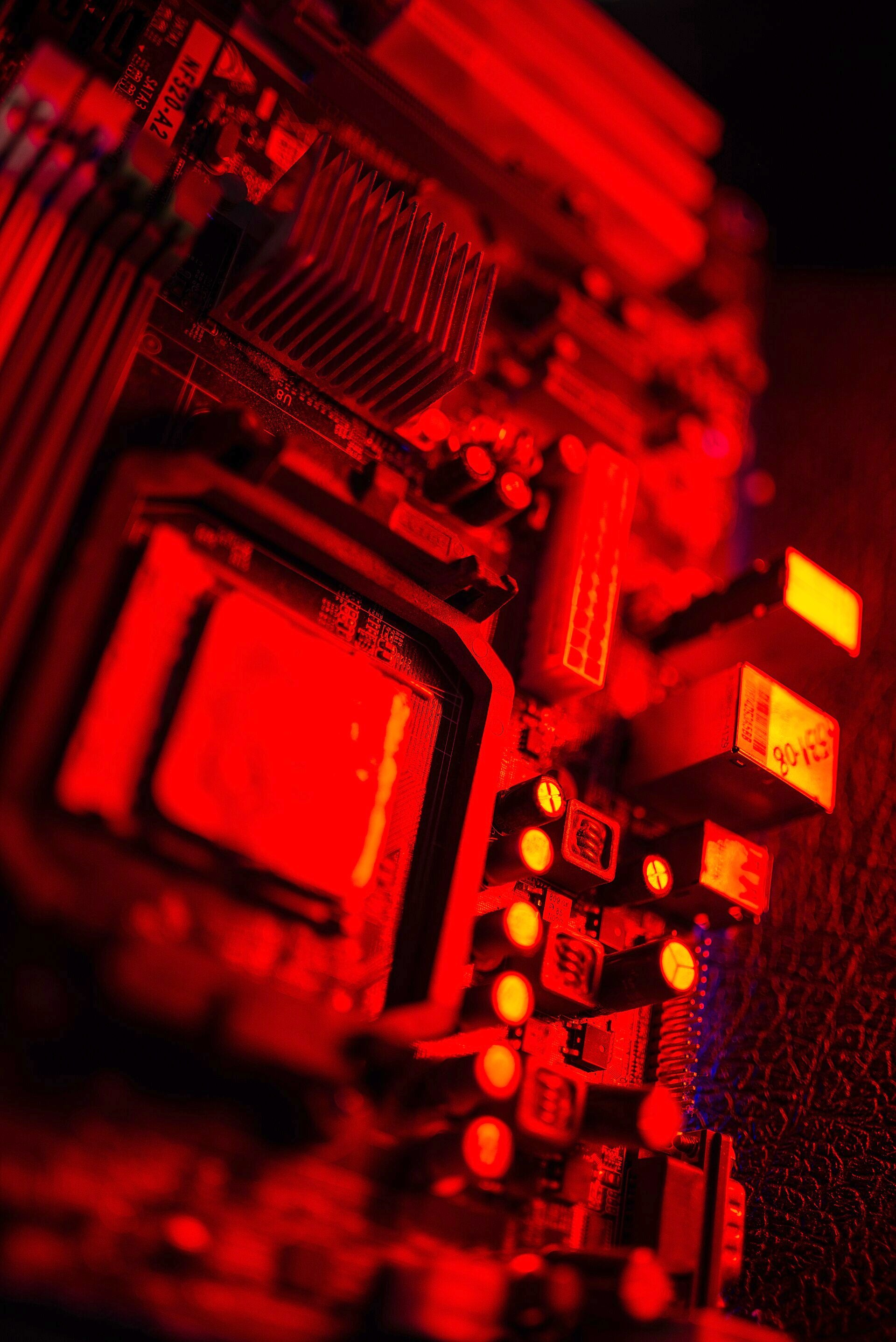 Close-up of a motherboard: the processor socket, heat sinks and capacitors, in black and white